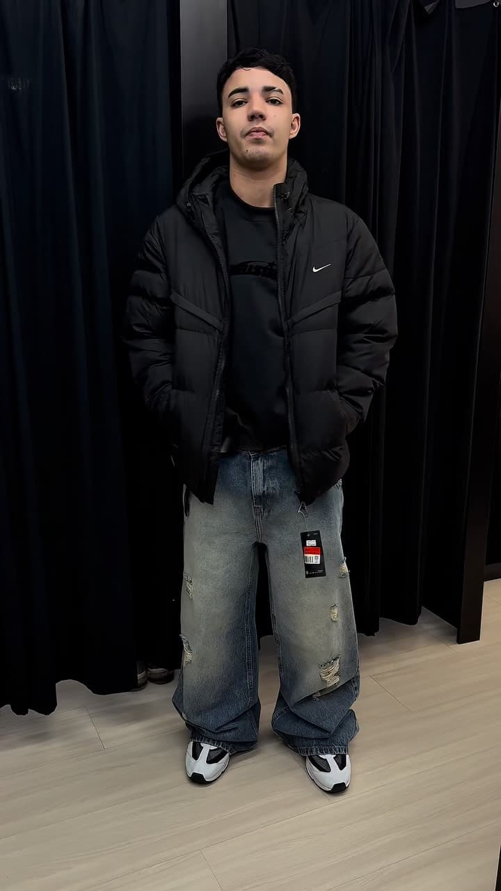 Modelo vestindo jaqueta puffer preta e calça baggy da Bella Black
